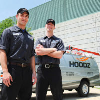 HOODZ restaurant hood cleaning franchise techs in front of vehicle