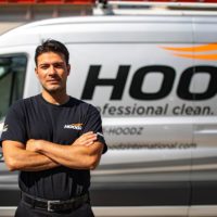 HOODZ franchise tech in front of company van
