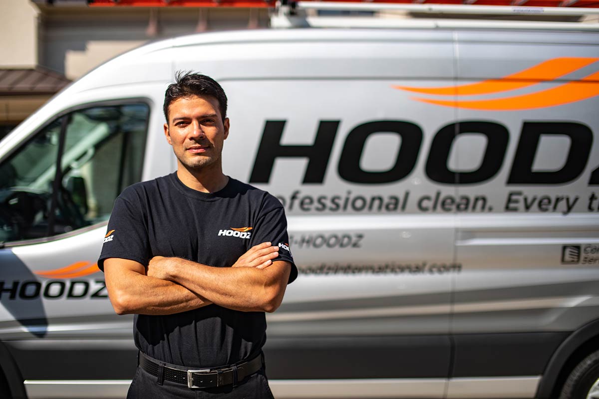 HOODZ franchise tech in front of company van