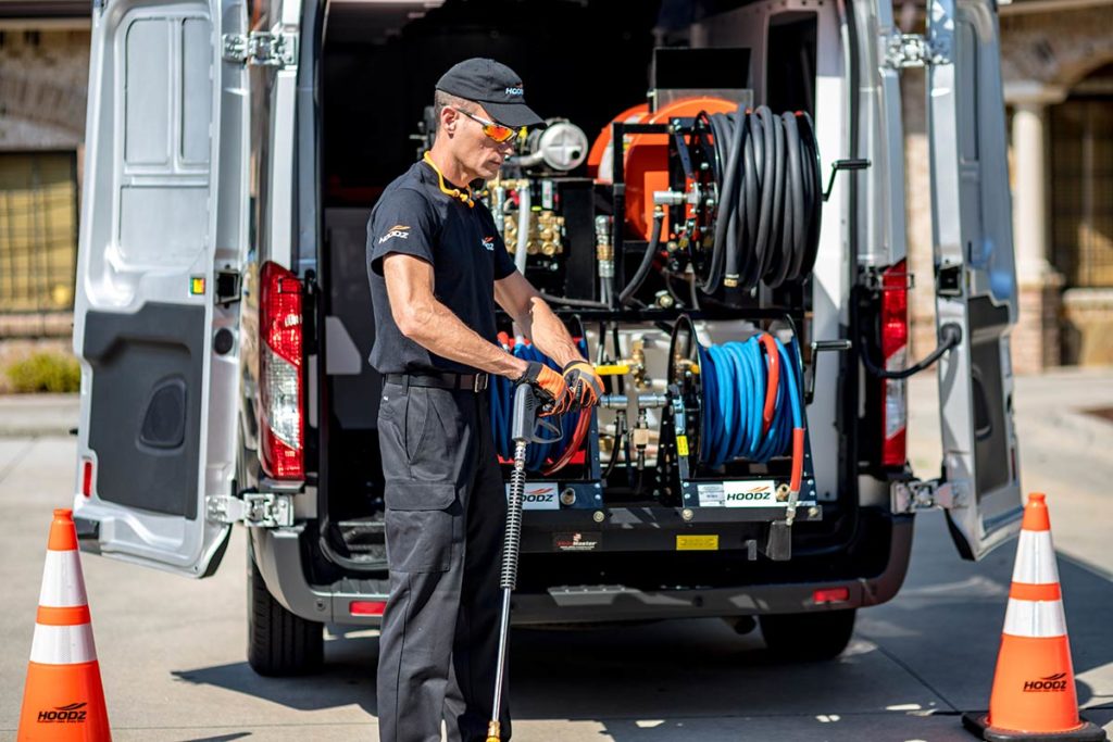 HOODZ technician grabbing gear from back of company van
